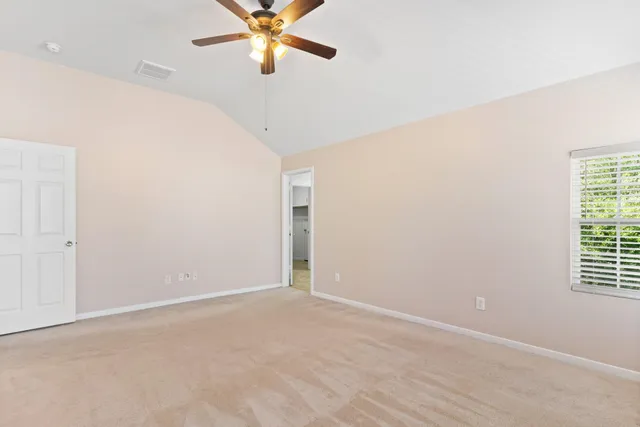 a view of a room with a window and a ceiling fan