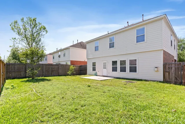 a backyard of a house with yard and deck