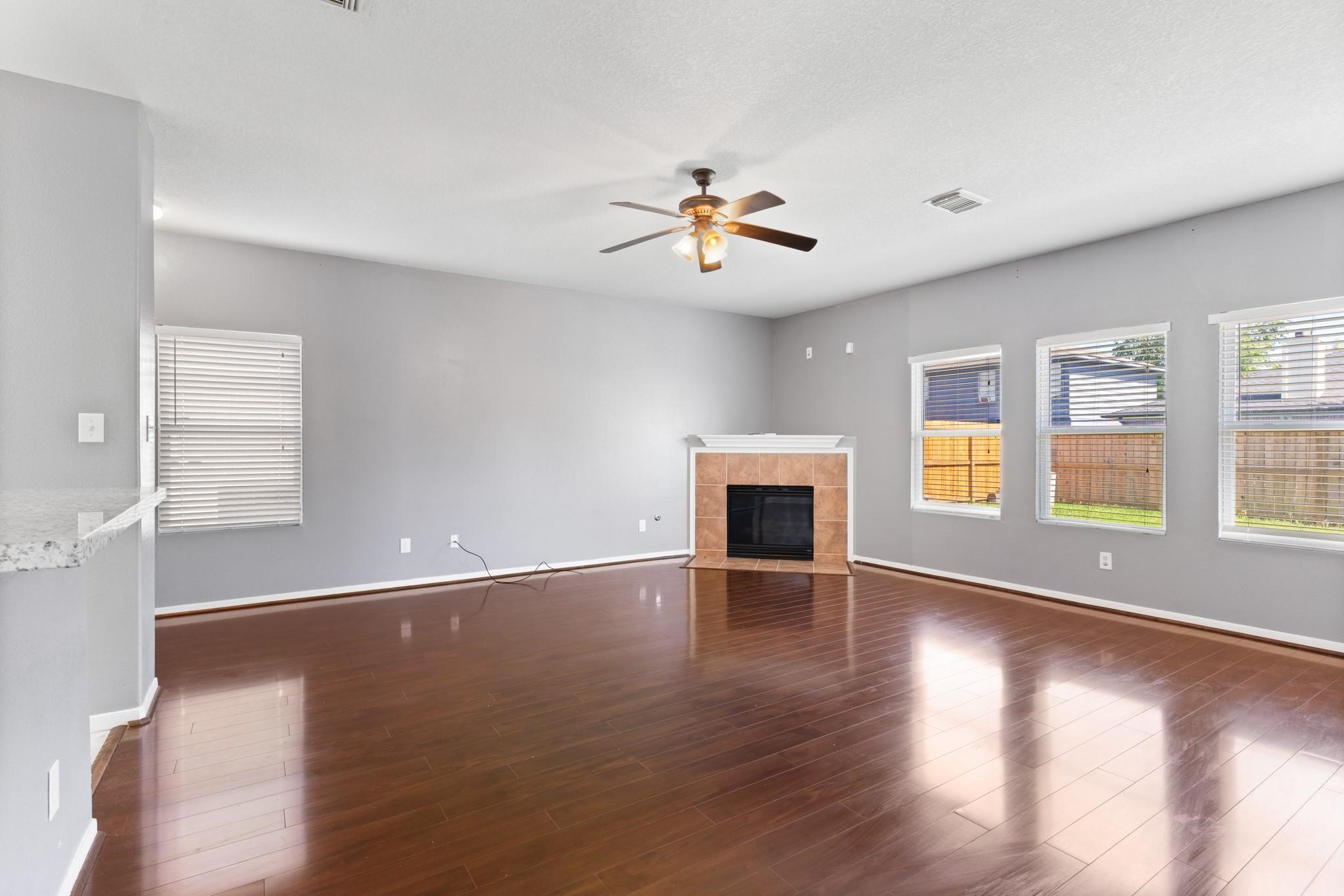 5038 Forest Hurst Drive Spring, TX 77373 - Photo 3 of 22 a view of an empty room with window and wooden floor