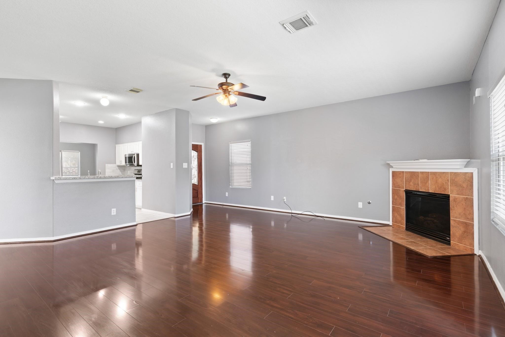 5038 Forest Hurst Drive Spring, TX 77373 - Photo 5 of 22 a view of an empty room with wooden floor and a fireplace