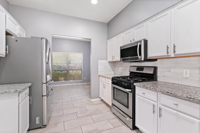 a kitchen with a stove a sink and a microwave