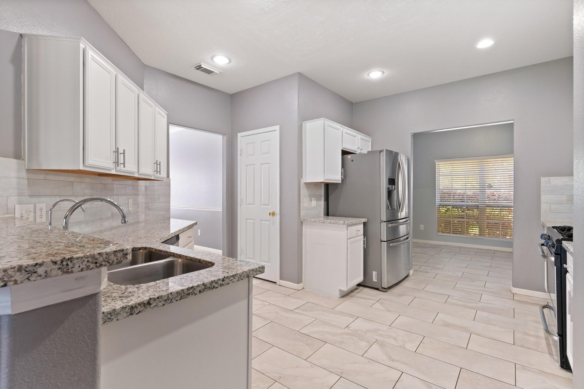 5038 Forest Hurst Drive Spring, TX 77373 - Photo 8 of 22 a kitchen with a sink cabinets and refrigerator