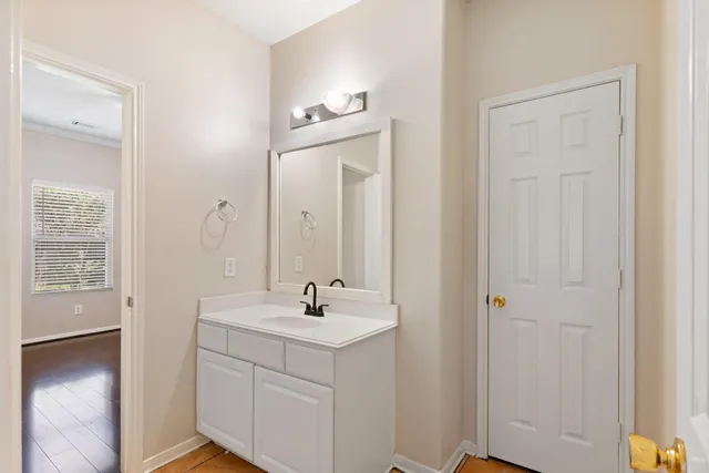 a bathroom with a sink a light fixture and a mirror