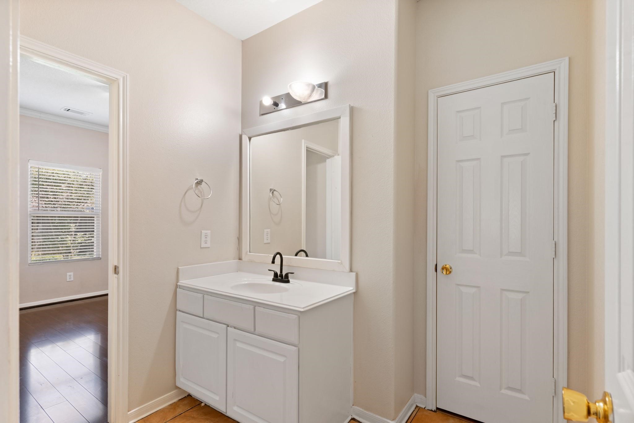 5038 Forest Hurst Drive Spring, TX 77373 - Photo 10 of 22 a bathroom with a sink a light fixture and a mirror