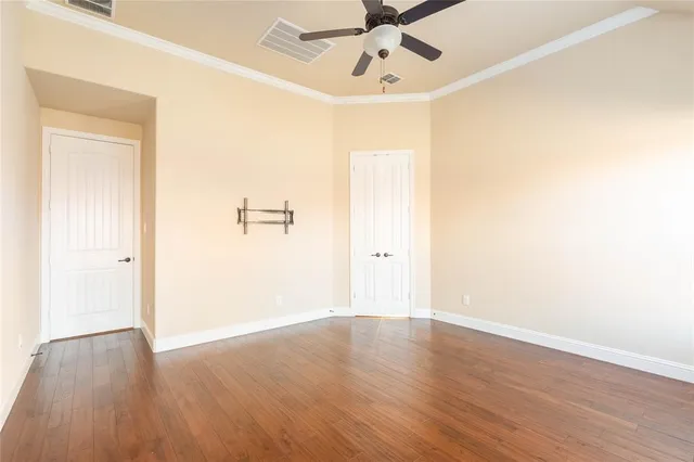a view of a room with wooden floor and closet area