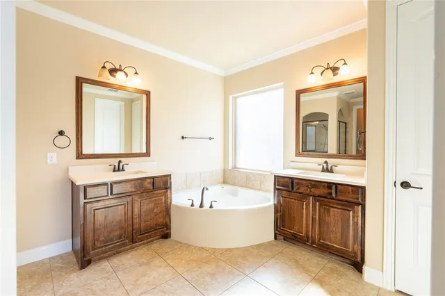 a bathroom with a bathtub sink and mirror