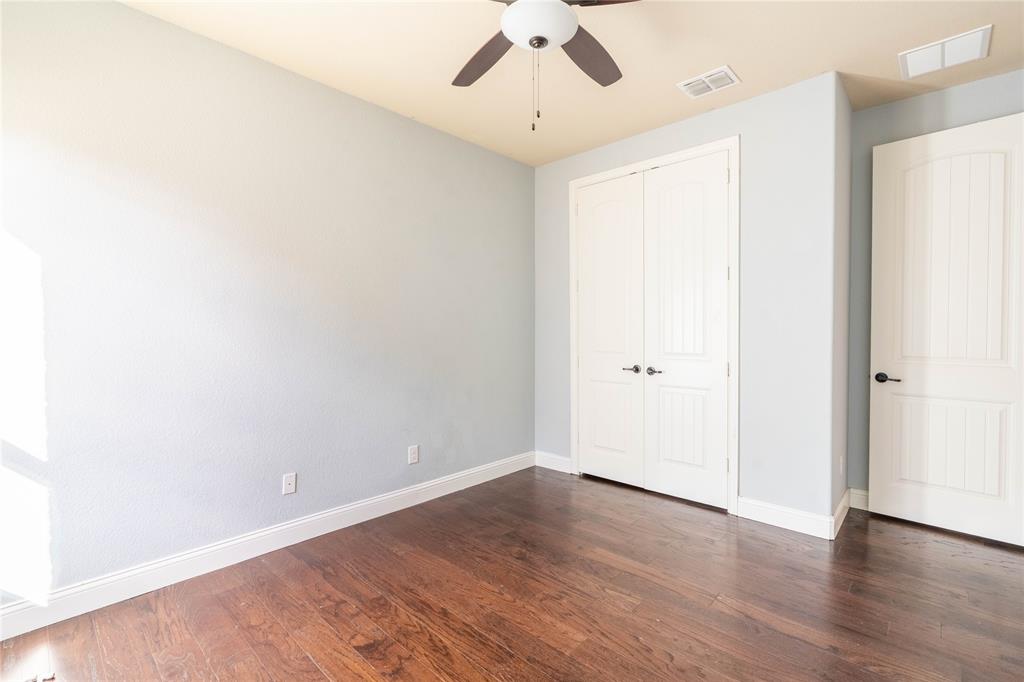 9101 Waters Lane Rowlett, TX 75089 - Photo 28 of 34 an empty room with wooden floor and ceiling fan
