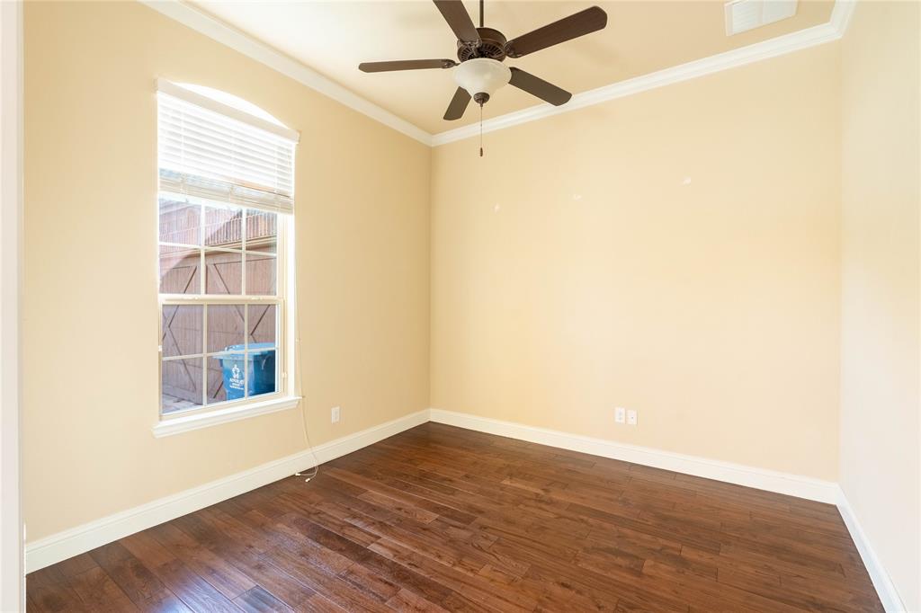 9101 Waters Lane Rowlett, TX 75089 - Photo 8 of 34 a view of an empty room with wooden floor and a window