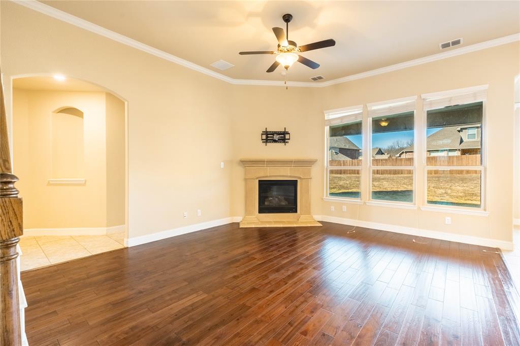 9101 Waters Lane Rowlett, TX 75089 - Photo 9 of 34 a view of an empty room with wooden floor and a window