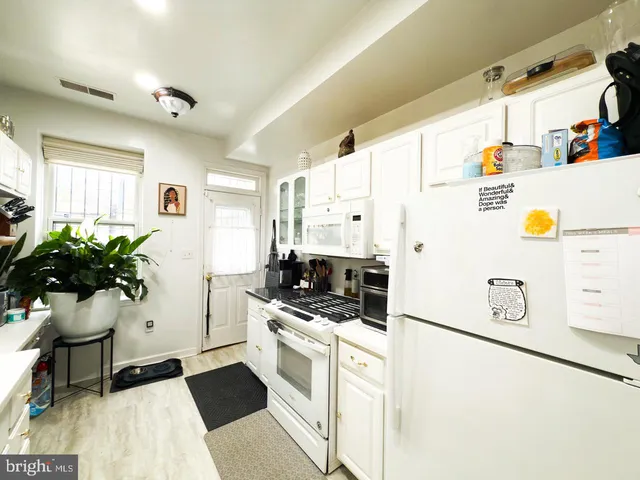 a kitchen with stainless steel appliances kitchen island granite countertop a sink and cabinets