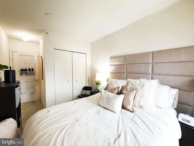 a bedroom with bed and a night stand