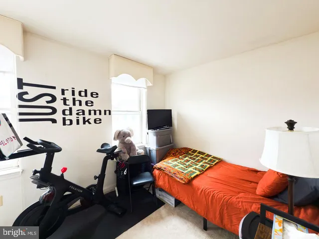 a bedroom with a bed and flat screen tv