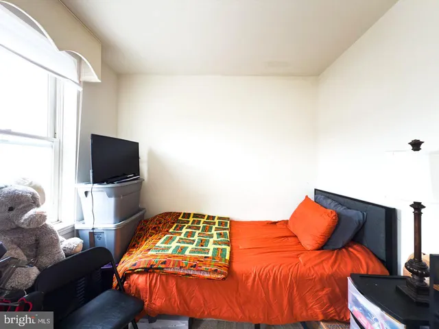 a bedroom with a bed and dresser