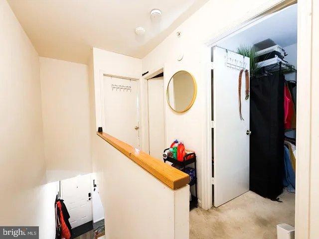 a bathroom with a granite countertop toilet sink and mirror