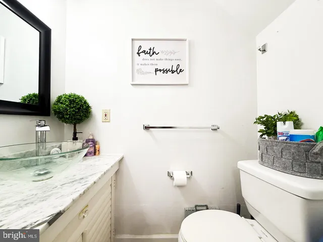a white toilet sitting next to a bathroom sink