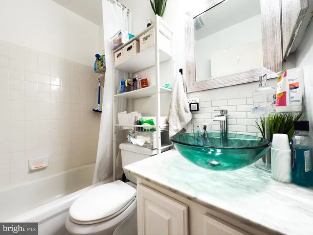 a kitchen with sink cabinets and potted plant