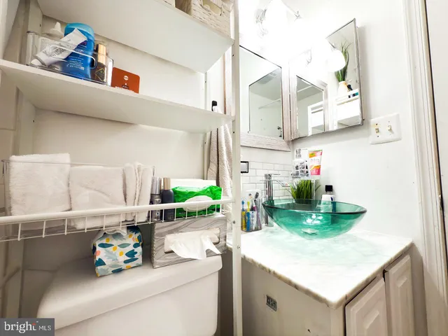 a room with a refrigerator and a sink