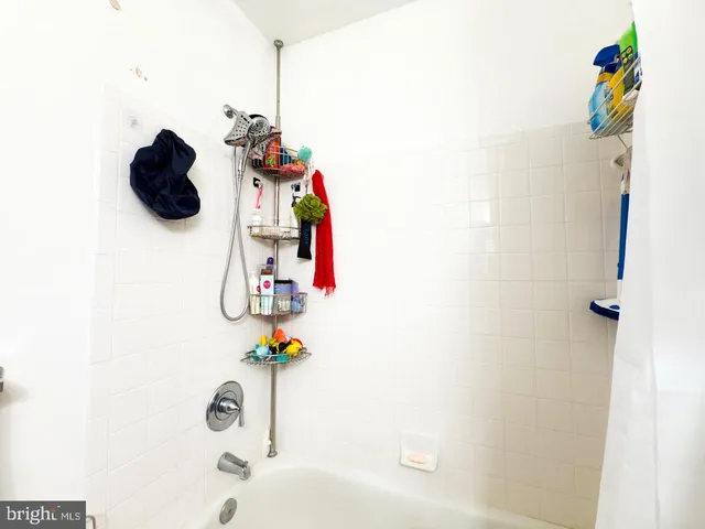 a bathroom with a sink toilet and shower curtain