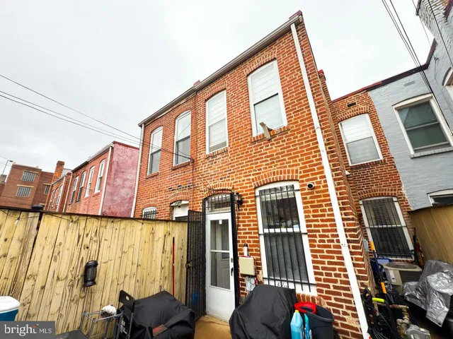 a view of a patio with couches and potted plants