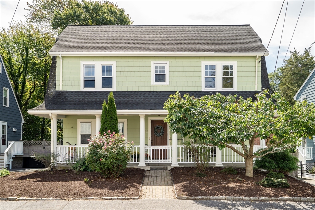 a front view of a house with a garden