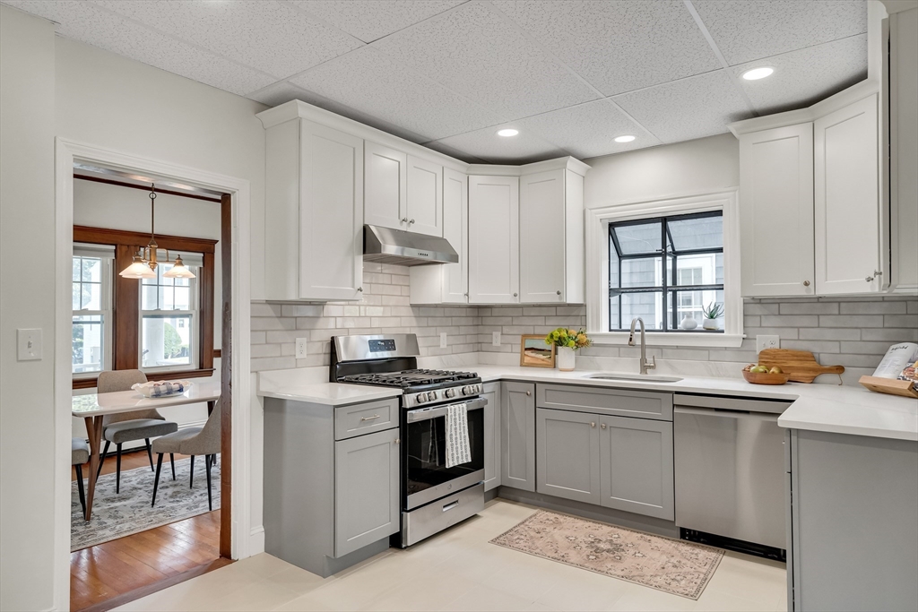 62 Florence Road Waltham, MA 02453 - Photo 12 of 42 a kitchen with a sink stove and cabinets
