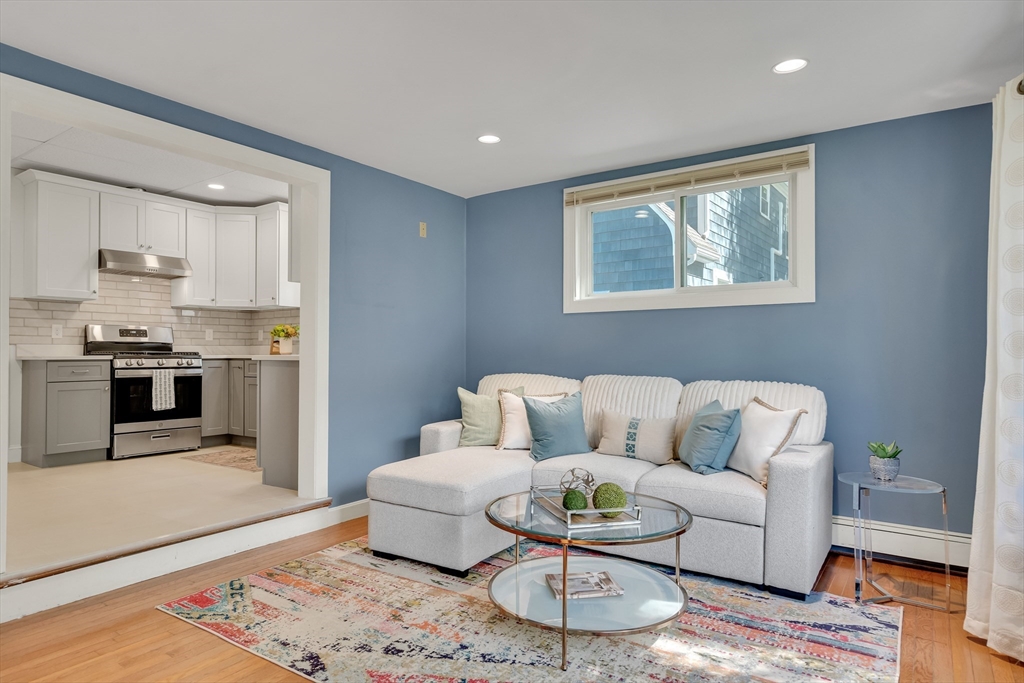 62 Florence Road Waltham, MA 02453 - Photo 19 of 42 a living room with furniture and a dining table with wooden floor