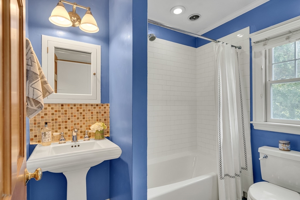 62 Florence Road Waltham, MA 02453 - Photo 25 of 42 a bathroom with a sink mirror and a bathtub