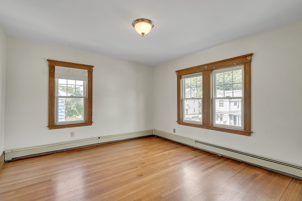 62 Florence Road Waltham, MA 02453 - Photo 27 of 42 a view of an empty room with wooden floor and a window