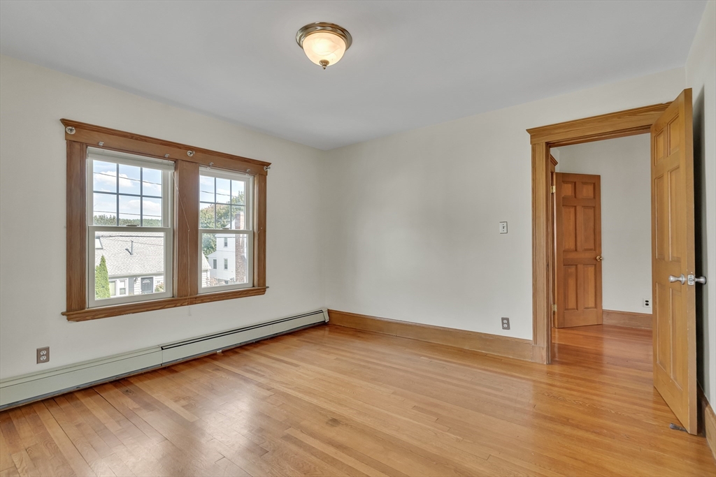62 Florence Road Waltham, MA 02453 - Photo 28 of 42 an empty room with wooden floor and windows