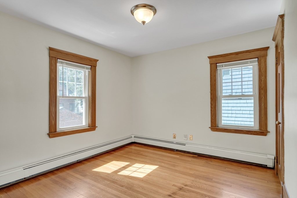 62 Florence Road Waltham, MA 02453 - Photo 29 of 42 a view of an empty room with wooden floor and a window