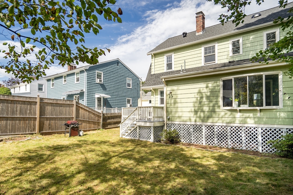 62 Florence Road Waltham, MA 02453 - Photo 36 of 42 a view of a house with a small yard and wooden fence