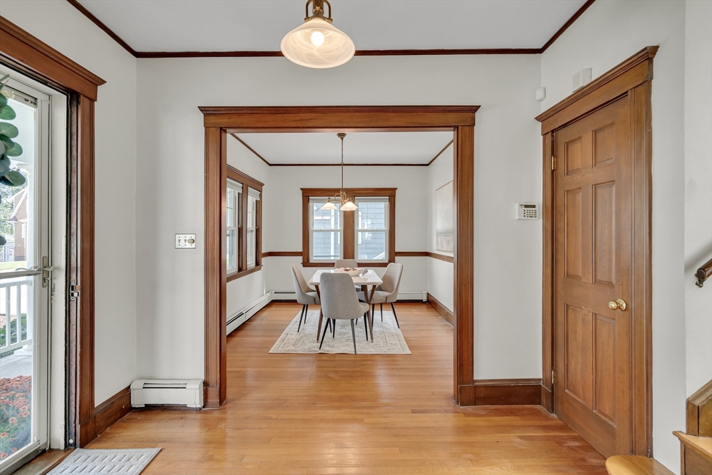 62 Florence Road Waltham, MA 02453 - Photo 6 of 42 a dining room with wooden floor a glass table and chairs