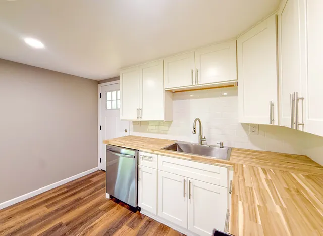 a kitchen with a sink stove and cabinets