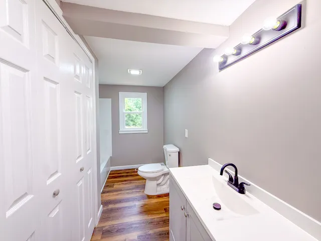 a bathroom with a sink a mirror and a shower