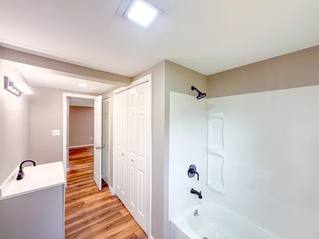 a bathroom with a bathtub and shower