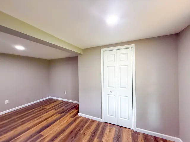 a view of a room with wooden floor