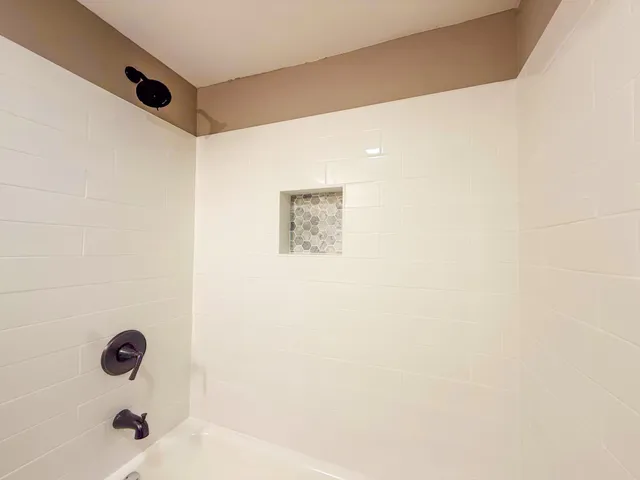 a bathroom with a shower and a sink