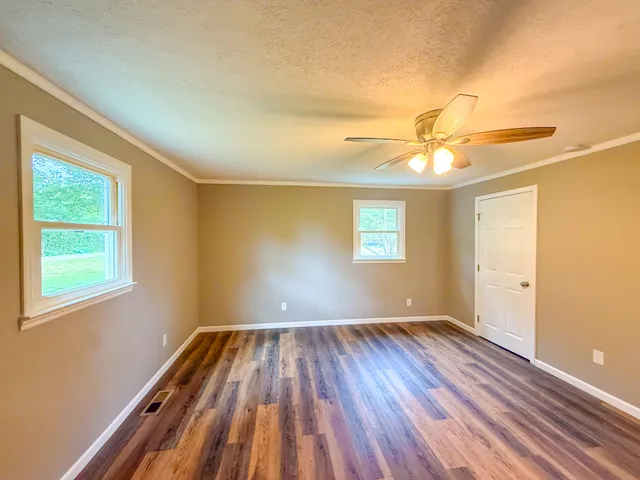 wooden floor in an empty room with a window