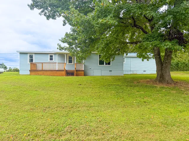 a house view with swimming pool in front of the house