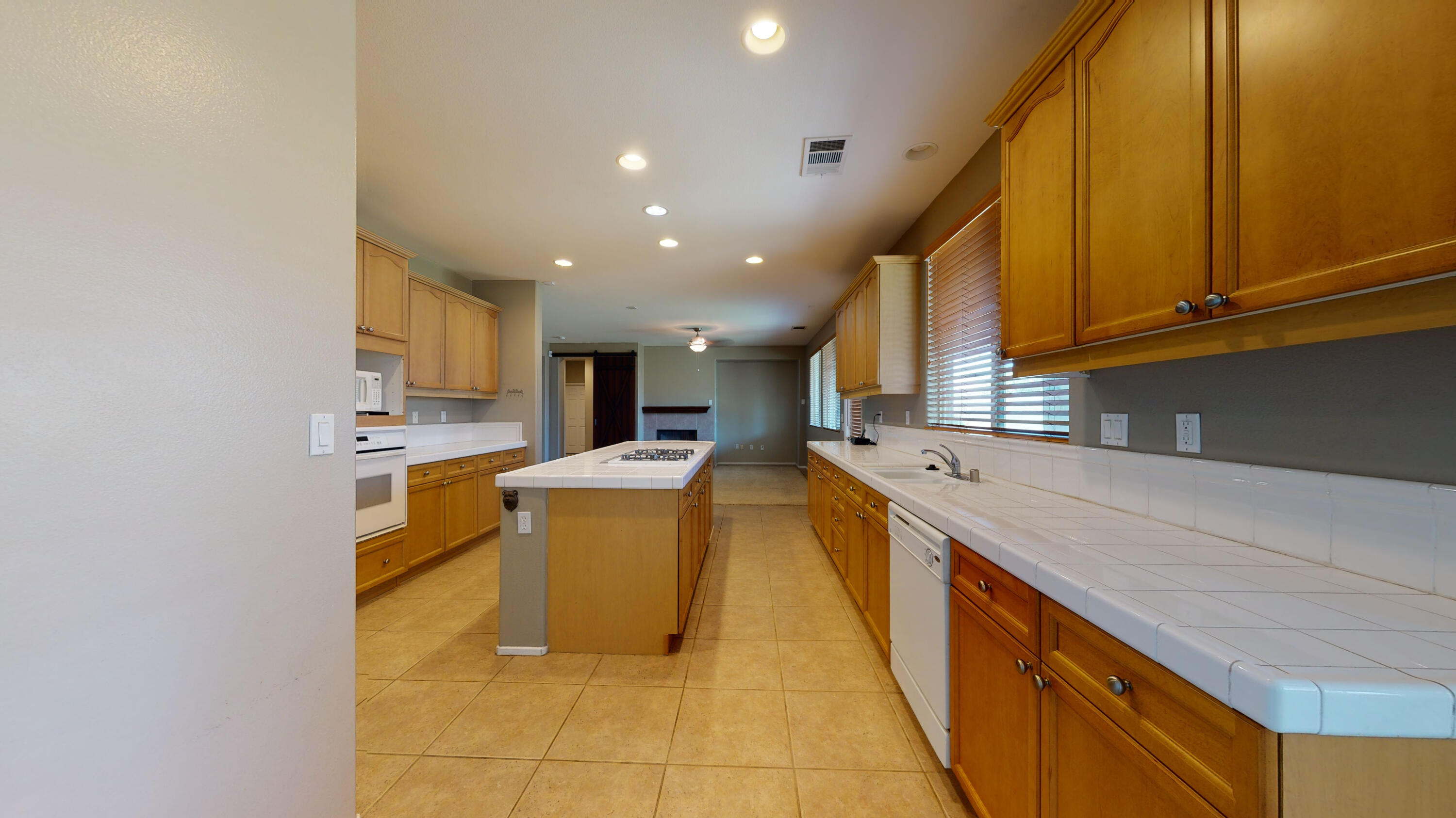 82712 Kyle Drive Indio, CA 92203 - Photo 19 of 29 a large kitchen with stainless steel appliances granite countertop a sink and cabinets