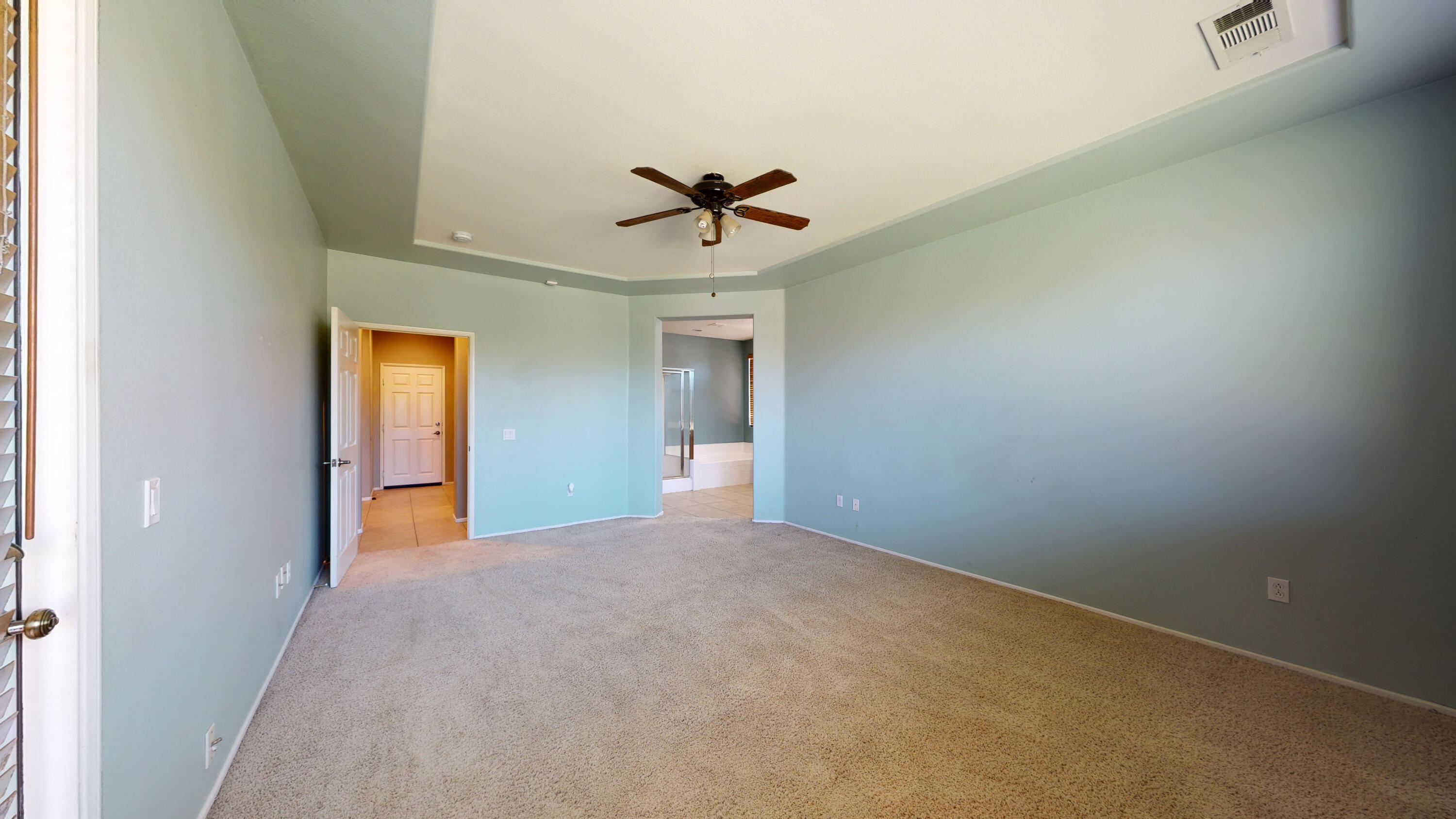 82712 Kyle Drive Indio, CA 92203 - Photo 23 of 29 an empty room with a ceiling fan and a window