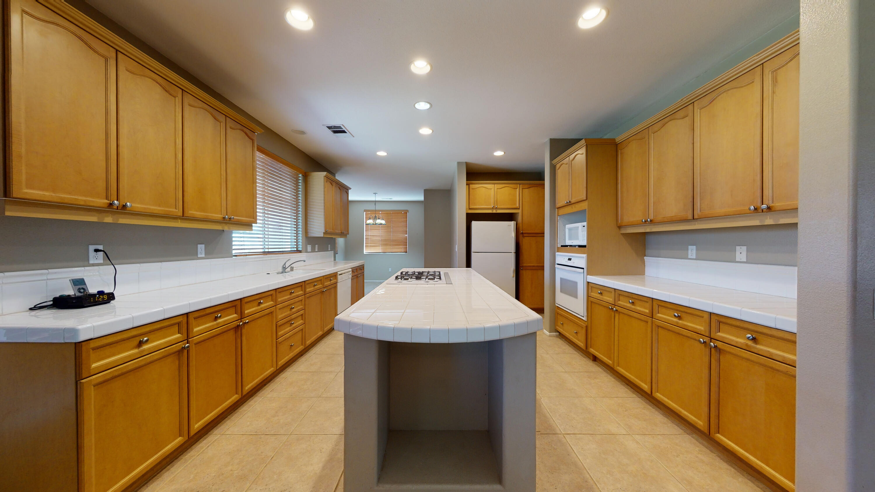 82712 Kyle Drive Indio, CA 92203 - Photo 28 of 29 a kitchen with stainless steel appliances kitchen island granite countertop a sink and cabinets