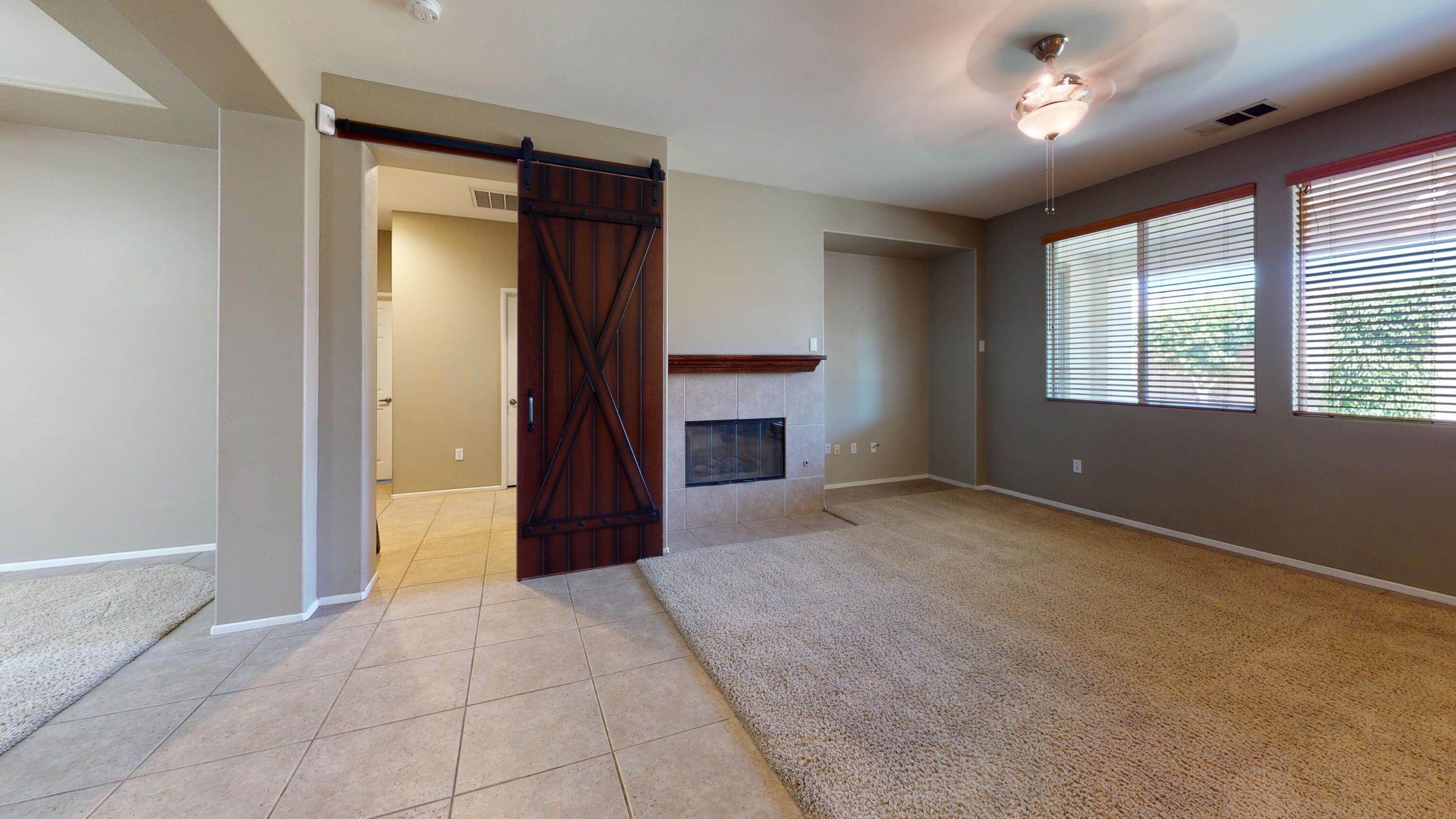 82712 Kyle Drive Indio, CA 92203 - Photo 3 of 29 a view of an empty room with a fireplace and a window