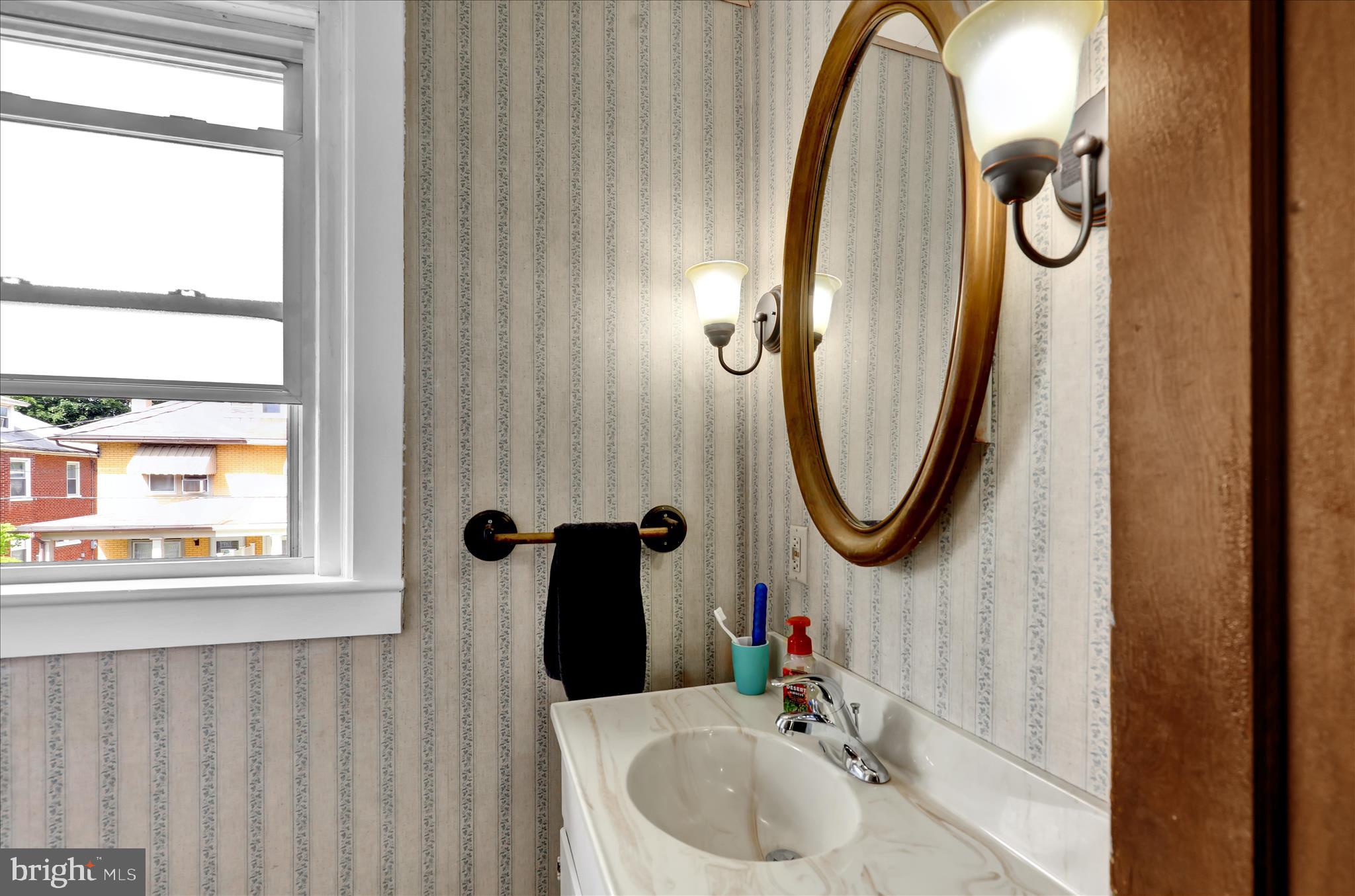 43 East Walnut Street Ephrata, PA 17522 - Photo 18 of 32 a bathroom with a sink a mirror and a window