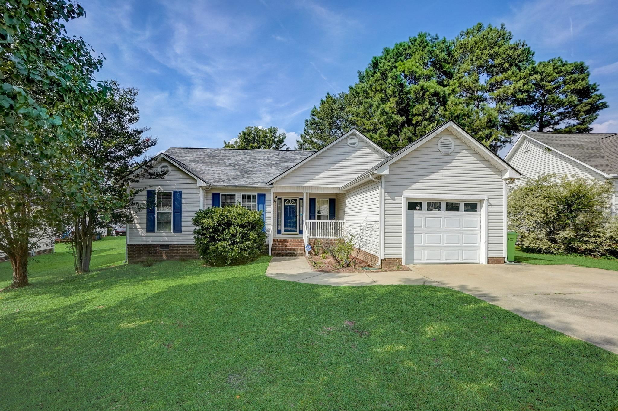 7133 Spanglers Spring Way Raleigh, NC 27610 - Photo 1 of 17 a front view of a house with a yard and trees