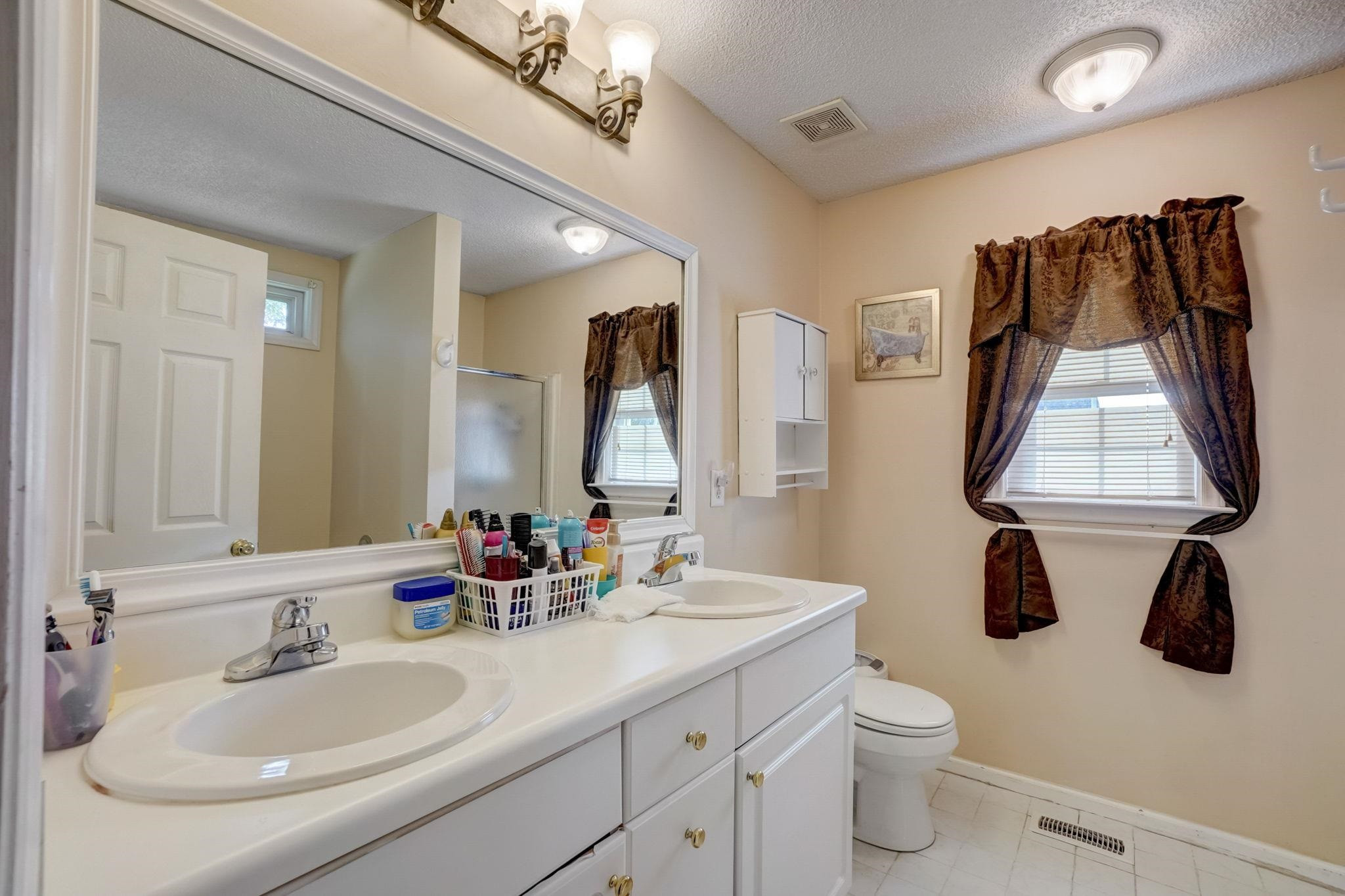 7133 Spanglers Spring Way Raleigh, NC 27610 - Photo 12 of 17 a bathroom with a sink and a toilet