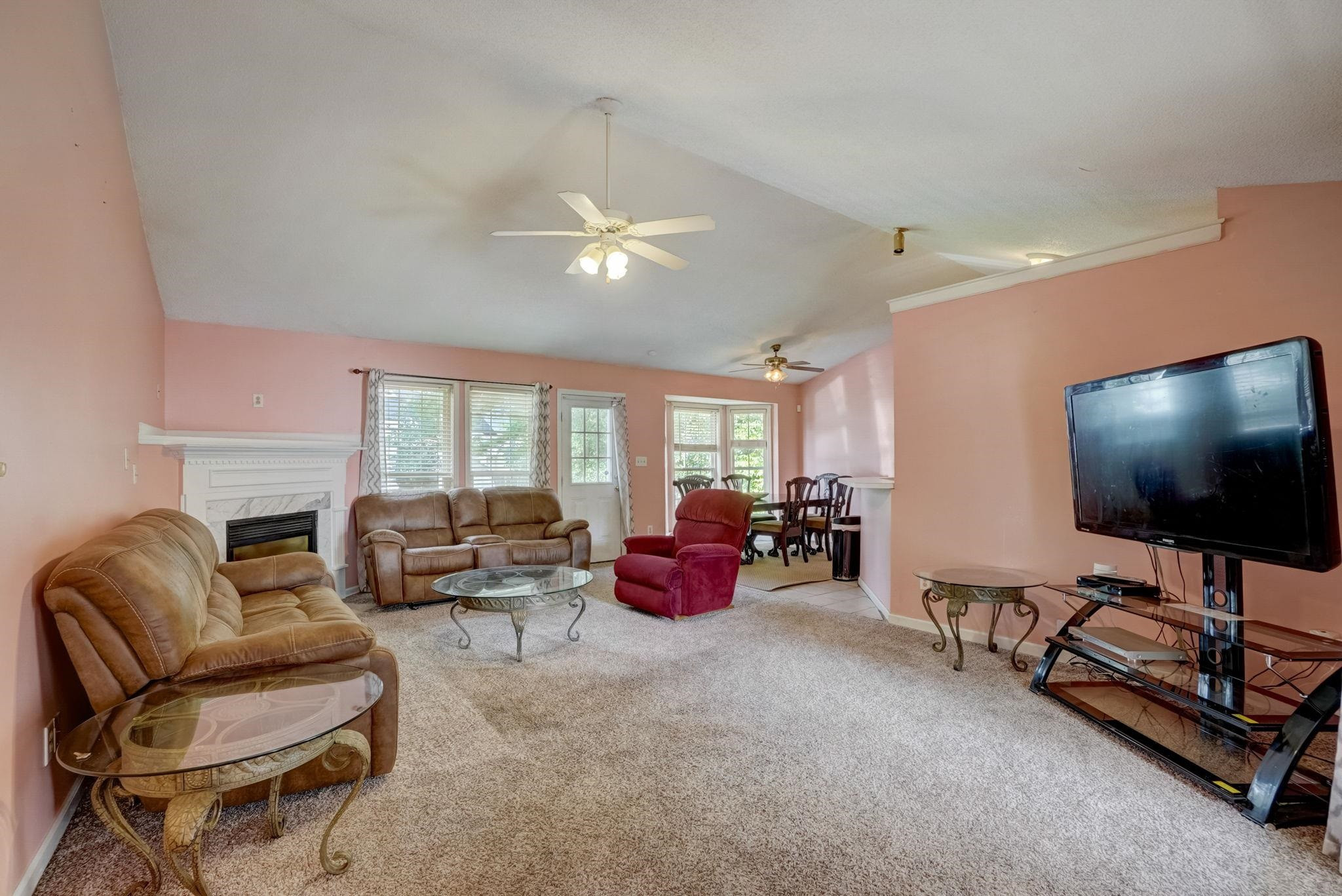 7133 Spanglers Spring Way Raleigh, NC 27610 - Photo 3 of 17 a living room with furniture flat screen tv and a large window