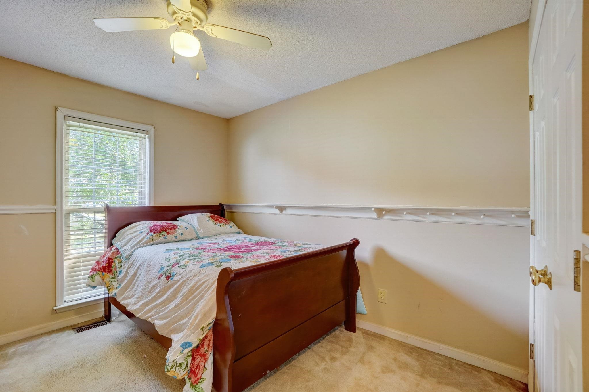 7133 Spanglers Spring Way Raleigh, NC 27610 - Photo 9 of 17 a bedroom with a bed and a chandelier