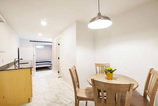 a bedroom with a bed and a lamp on the dresser