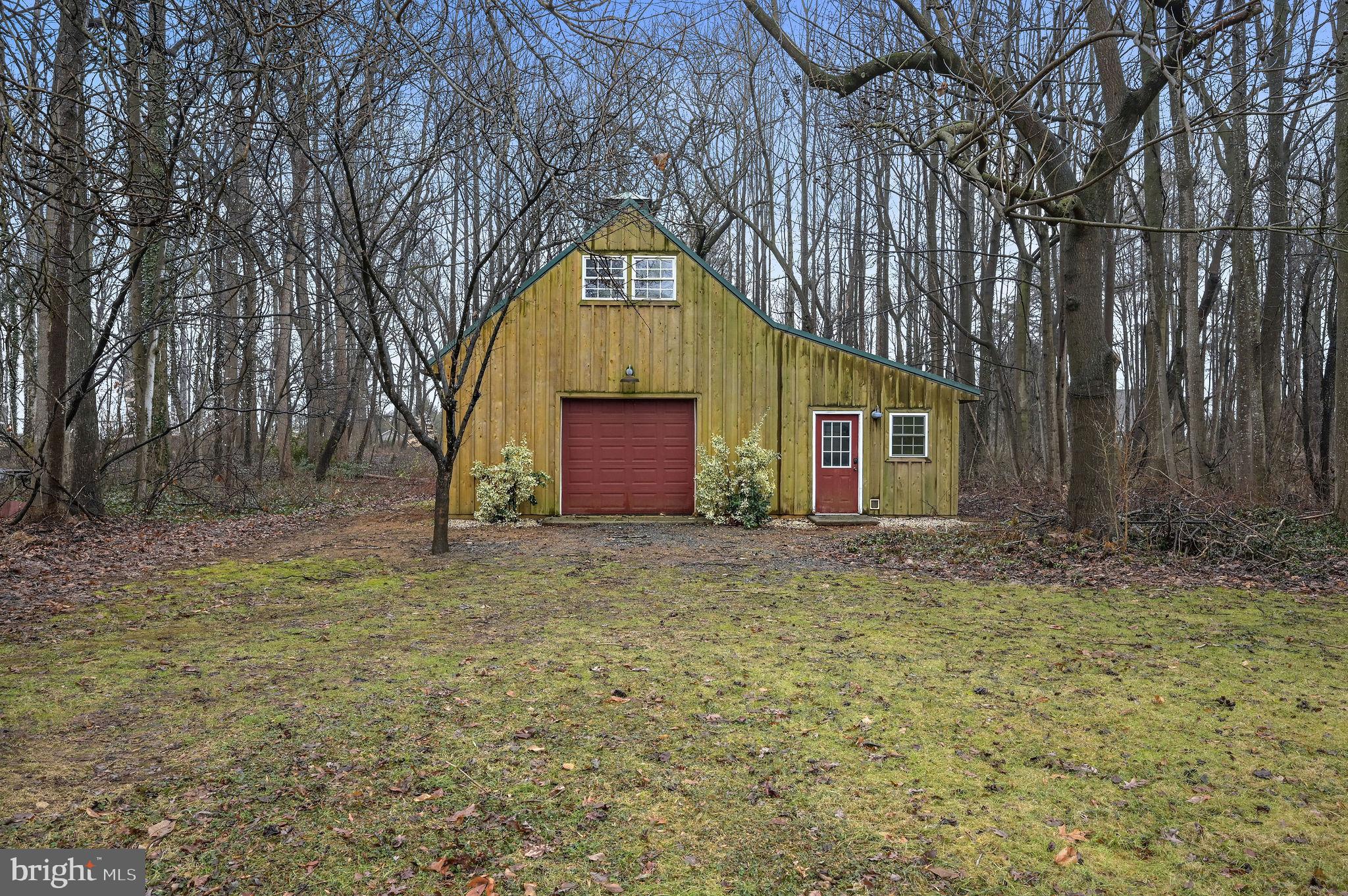 334 Sophers Row Magnolia, DE 19962 - Photo 15 of 47 a backyard of a house with a yard and garage